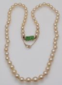 An early 20th century cultured pearl necklace, on a fine jadeite clasp