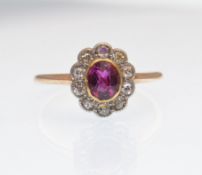 AN 18CT GOLD RUBY AND DIAMOND LADIED CLUSTER RING