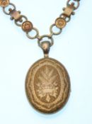 A Georgian locket on chain. The book chain having domed roundels with cannetille work stars with