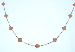 An 18ct gold Alhambra necklace strung with 15 Alhambra motifs possibly angle skin coral on a fancy
