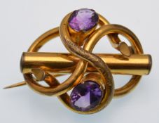 A late Victorian amethyst set brooch. The brooch being set with two oval cut amethyst within a
