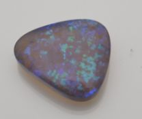 A single loose natural precious opal showing mainly blue and green play of colour. Weight 15.5cts.