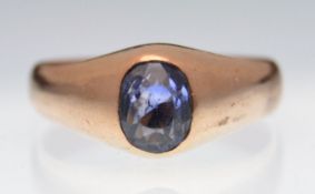 An early 20th century gold and sapphire single stone gypsy ring