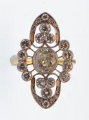 An Edwardian 18ct gold and diamond ring. The ring having an openwork setting having a central old