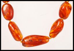 A 20th Century amber graduating beaded necklace se