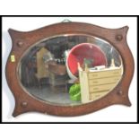 A vintage 1920's Art Deco oval wall mirror having