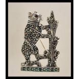 A sterling silver brooch in the form of a bear dec