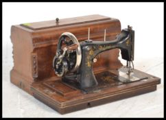 A vintage early 20th Century hand crank cased sewi