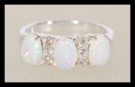 A sterling silver opal ring having three opal pane