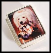 A silver pill / trinket box having an enamelled pa