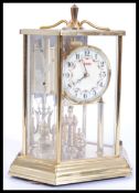 A 20th century brass anniversary clock with glass