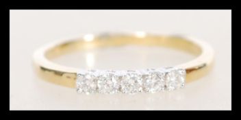 A stamped 18ct gold ring set with five diamonds. W