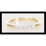 A stamped 18ct gold ring set with five diamonds. W