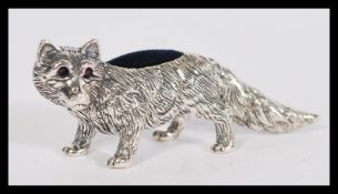 A sterling silver novelty pincushion in the form o