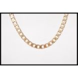 A stamped 375 9ct gold curb chain necklace set wit