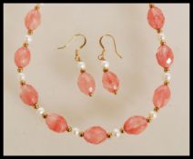 A necklace of rose quartz faceted beads with pearl