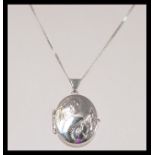 A stamped 375 white gold necklace with a spring ri