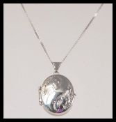 A stamped 375 white gold necklace with a spring ri