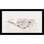 A stamped 14ct gold crossover ring prong set with