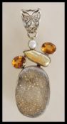 A stamped 925 silver pendant set with a citrines,