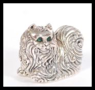 A sterling silver figurine in the form of a cat ha