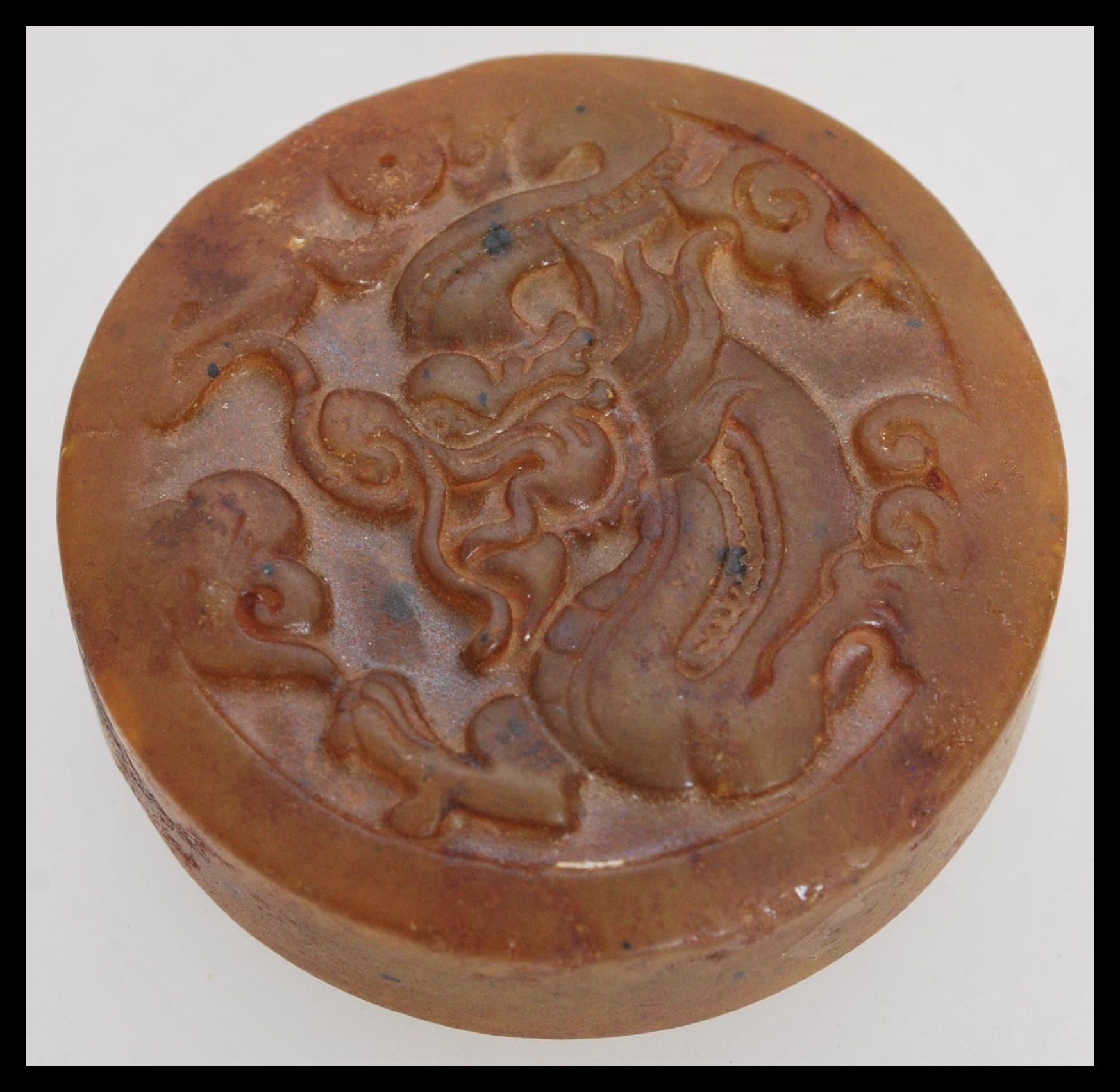 A Chinese Jade roundel seal of mottled brown colou