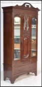 An Edwardian Art Nouveau walnut single wardrobe. R