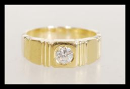 An 18ct gold diamond band ring having an inset dia