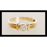 An 18ct gold diamond ring having an inset diamond