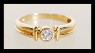 An 18ct gold diamond ring having an inset diamond
