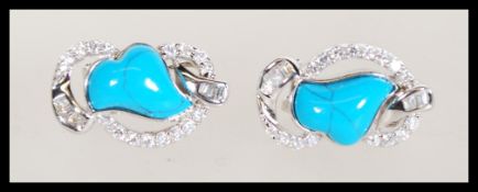 A pair of sterling silver and turquoise set earrin