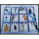 A selection of art glass pendants of different col