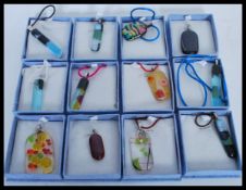 A selection of art glass pendants of different col