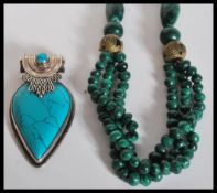 A beaded malachite necklace with bronzed tribal be