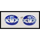 A pair of sterling silver and enamel set cufflinks