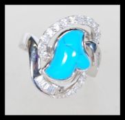A sterling silver turquoise set dress ring  having