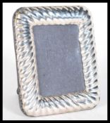 A sterling silver miniature easel back picture fra