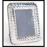 A sterling silver miniature easel back picture fra