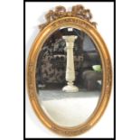 A 20th Century French Rococo style mirror of oval