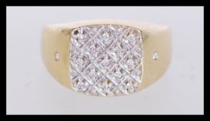 An 18ct gold ring having a square head set with wh