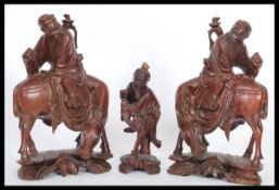 A pair of 20th Century Chinese carved figurines of