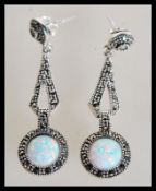 A pair of sterling silver CZ and opal drop earring