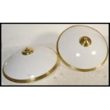 A pair of large circular flush ceiling lights with