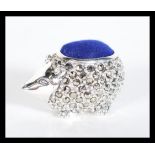 A sterling silver and marcasite set pincushion in