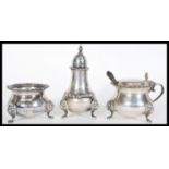 A set of three hallmarked silver cruets by Harrods