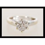 A hallmarked 18ct white gold diamond cluster ring