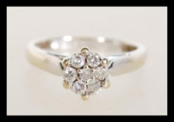 A hallmarked 18ct white gold diamond cluster ring