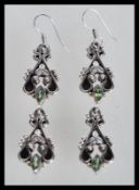 A pair of sterling silver drop earrings having per
