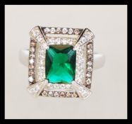 A sterling silver CZ and faux emerald dress ring i