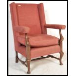 A 19th Century Georgian style wingback armchair, t